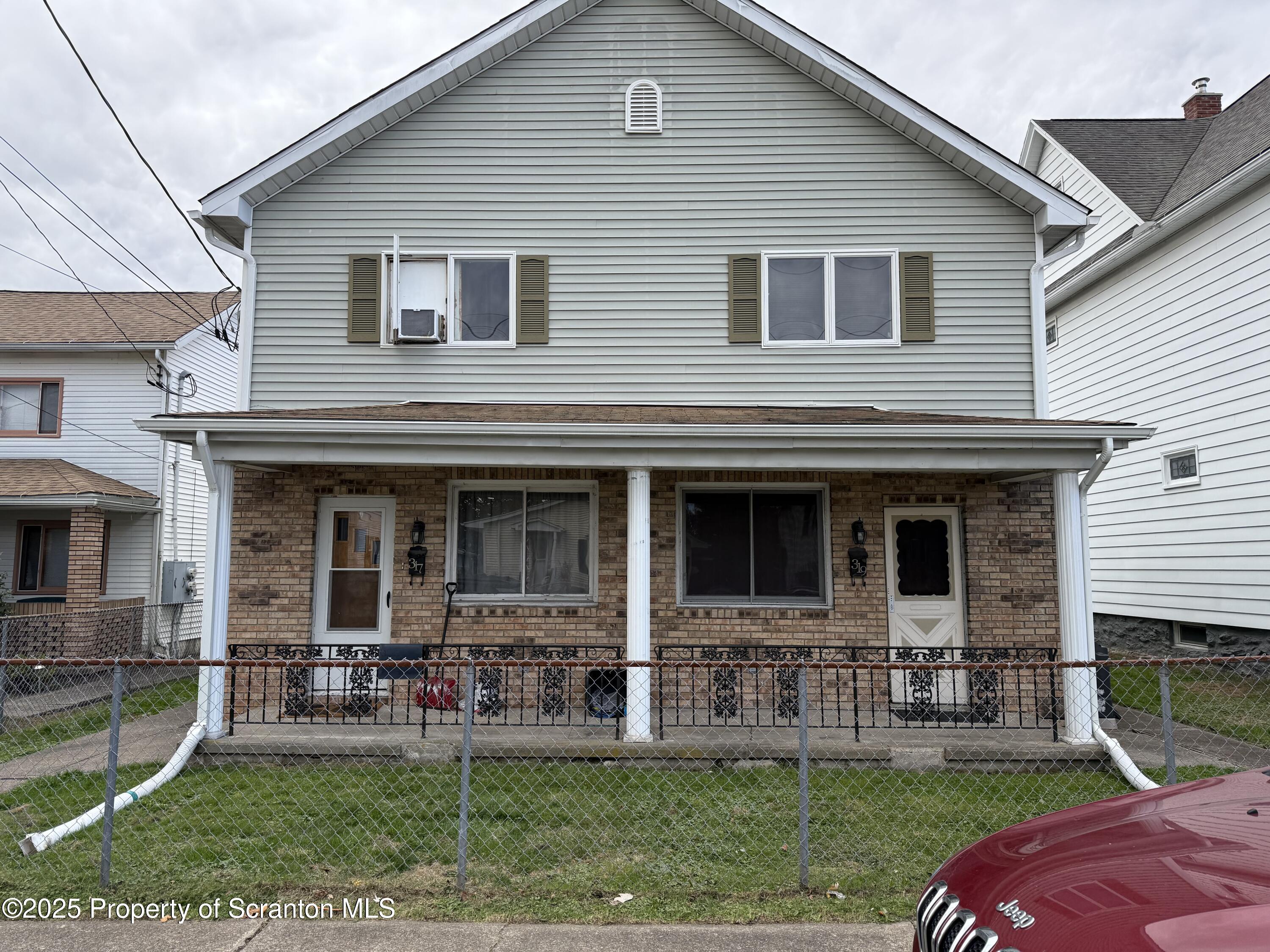 a view of a house with a yard and sitting area
