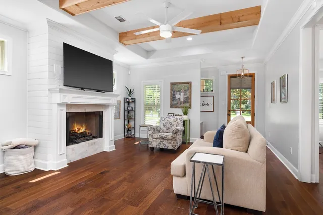 a living room with furniture fireplace and flat screen tv