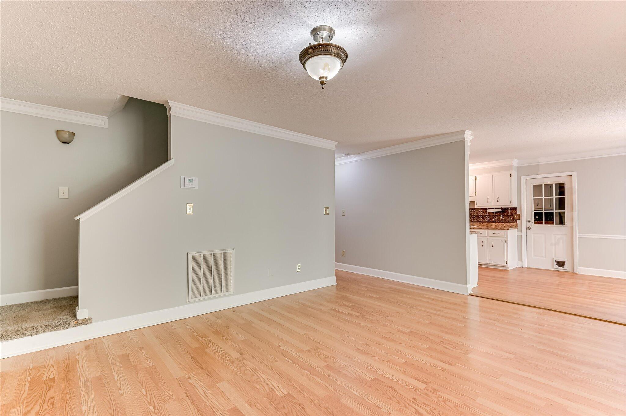 4686 Perry Mill Circle Grovetown, GA 30813 - Photo 16 of 57 View of stairs and kitchen from great room and hallway that leads to foyer