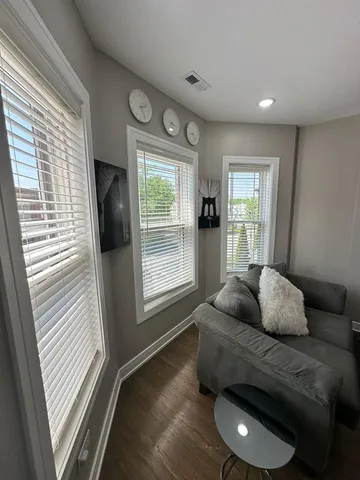 a bedroom with furniture and a window
