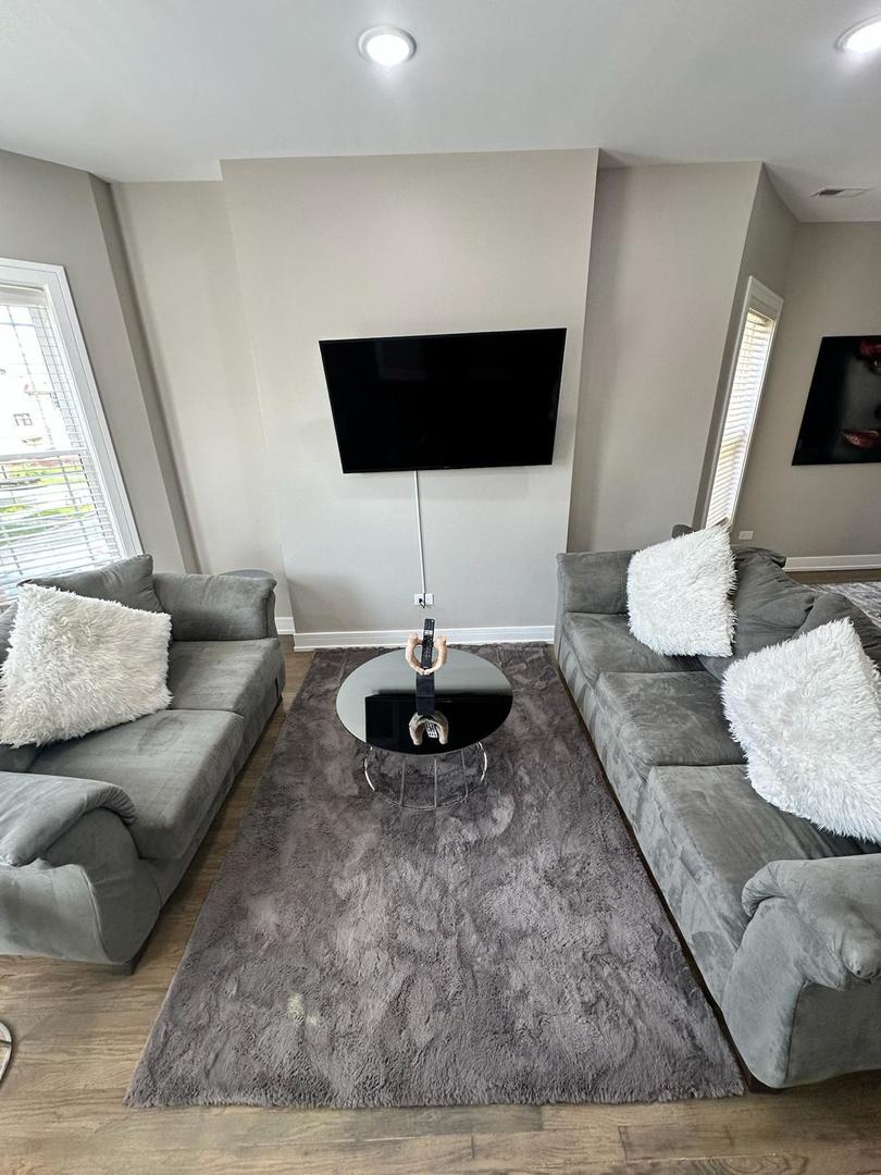 6807 South Calumet Avenue, Unit 2 Chicago, IL 60637 - Photo 3 of 12 a living room with furniture and a wooden floor