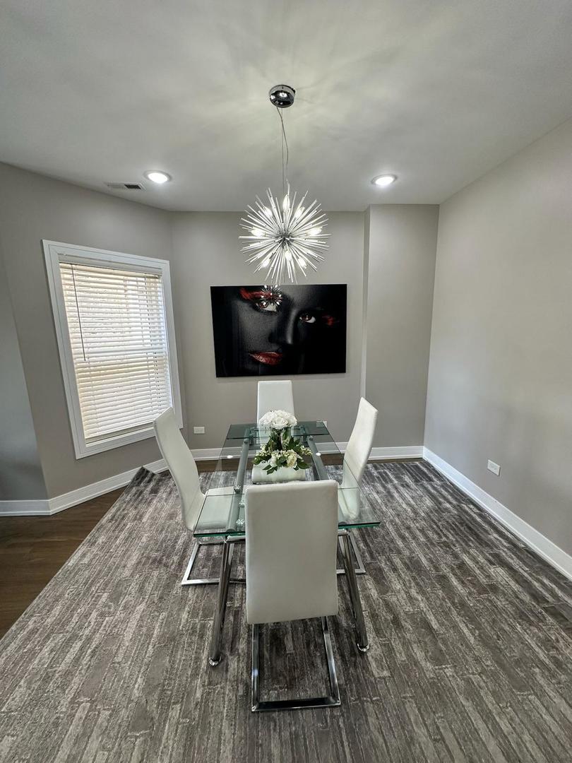 6807 South Calumet Avenue, Unit 2 Chicago, IL 60637 - Photo 4 of 12 a view of a dining room with furniture and chandelier