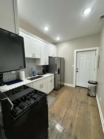 a kitchen with a stove and a refrigerator