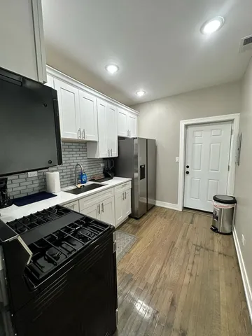 a kitchen with a stove and a refrigerator