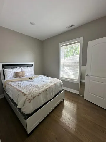 a bedroom with a bed and a window