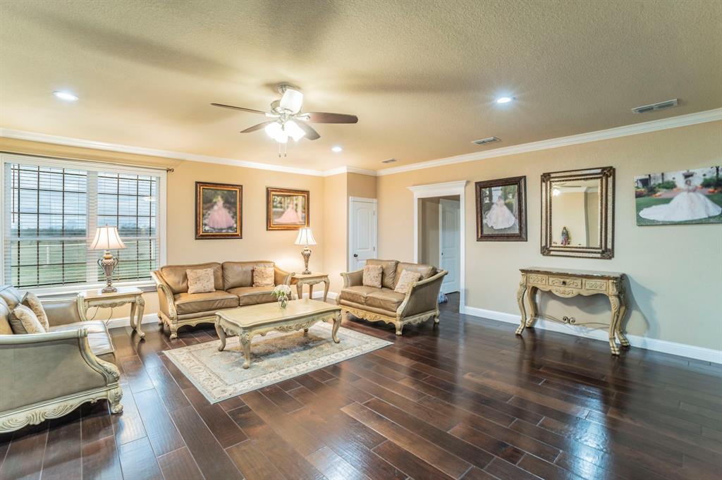 1019 Gin Road Ennis, TX 75119 - Photo 12 of 40 a living room with furniture and a wooden floor