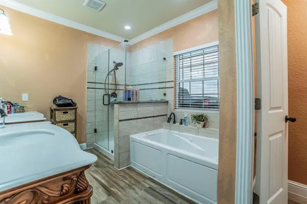 a bathroom with a sink a bathtub and a shower