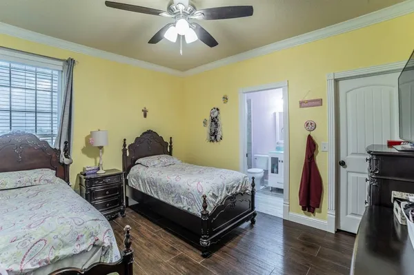 a bedroom with two beds and a chandelier