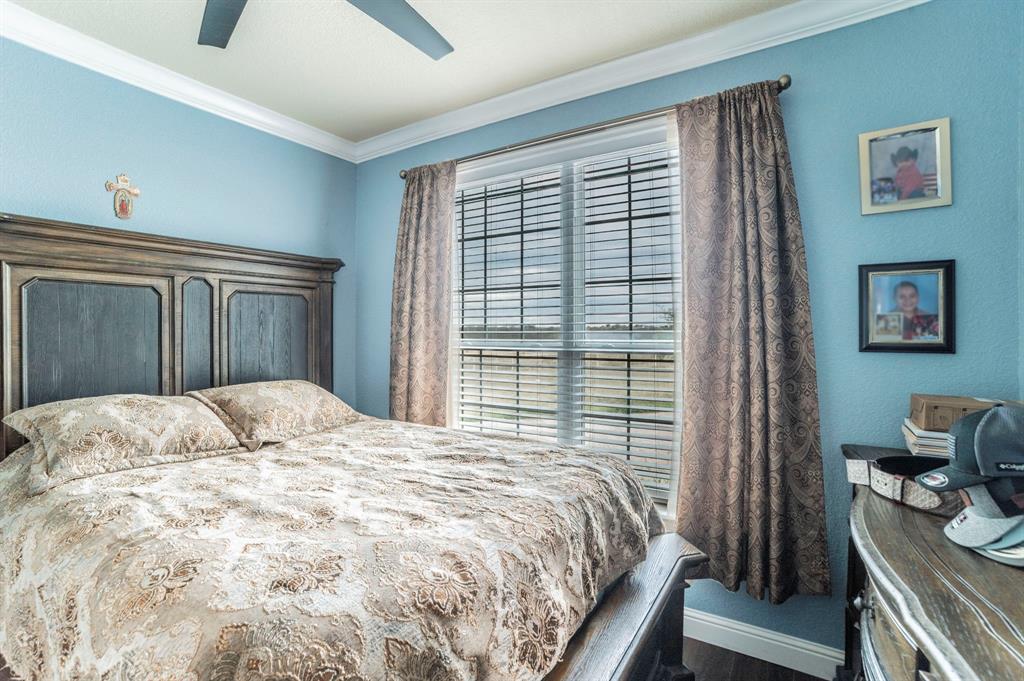 1019 Gin Road Ennis, TX 75119 - Photo 21 of 40 a bedroom with a bed and a window