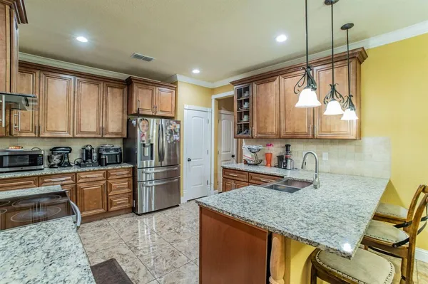 a kitchen with refrigerator cabinets and furniture
