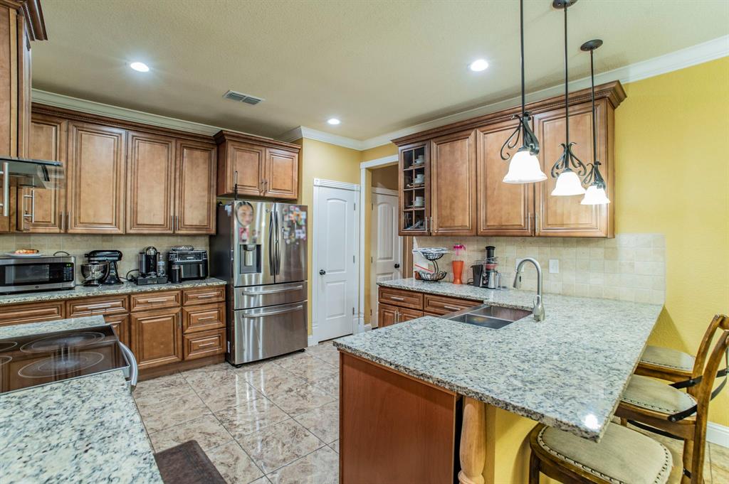 1019 Gin Road Ennis, TX 75119 - Photo 4 of 40 a kitchen with refrigerator cabinets and furniture