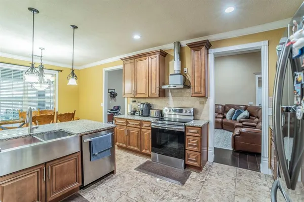 a kitchen with stainless steel appliances granite countertop a sink stove and refrigerator