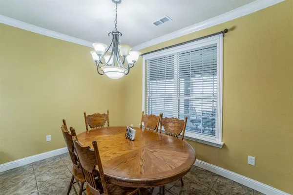 a view of a dining room with furniture and chandelier