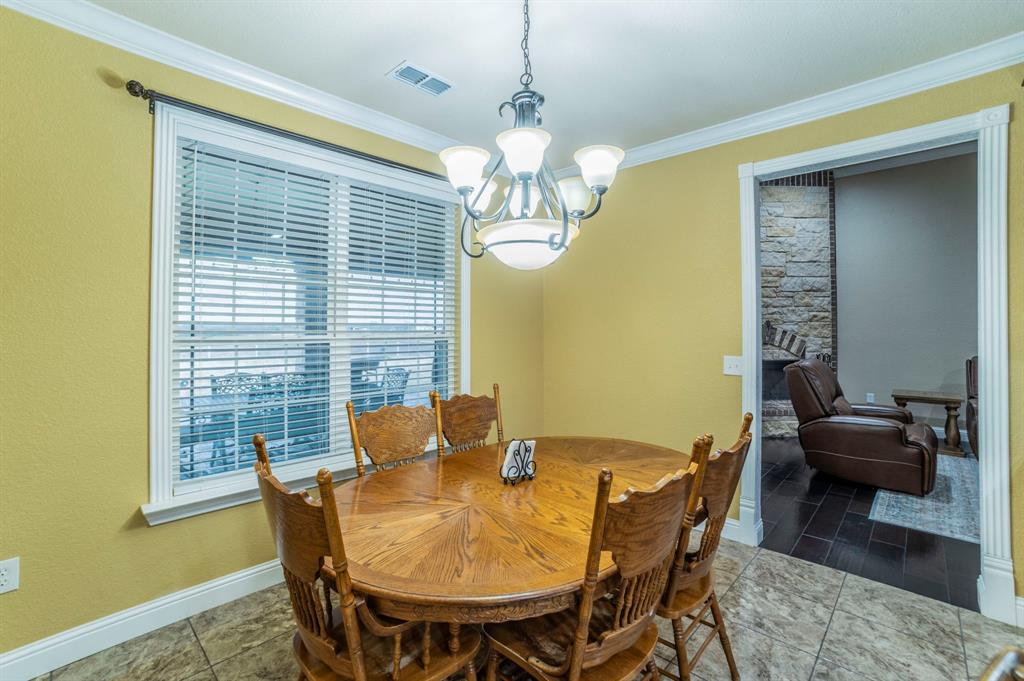 1019 Gin Road Ennis, TX 75119 - Photo 8 of 40 a view of a dining room with furniture and chandelier