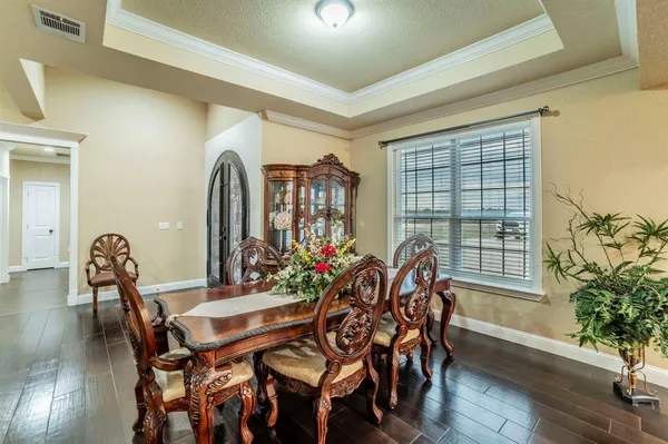 a view of a dining room with furniture and wooden floor