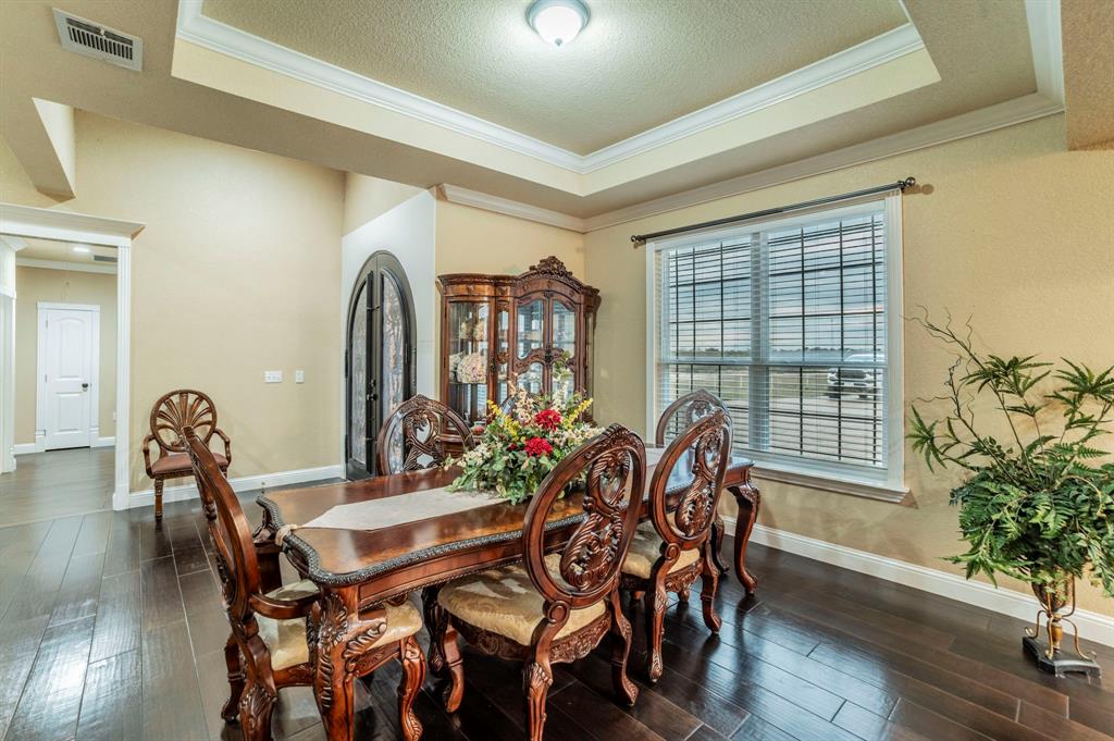 1019 Gin Road Ennis, TX 75119 - Photo 9 of 40 a view of a dining room with furniture and wooden floor