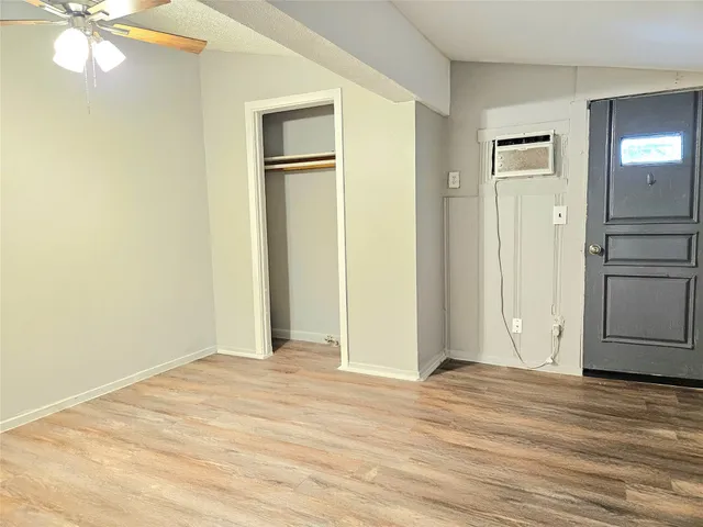 a view of a livingroom with wooden floor and a ceiling fan