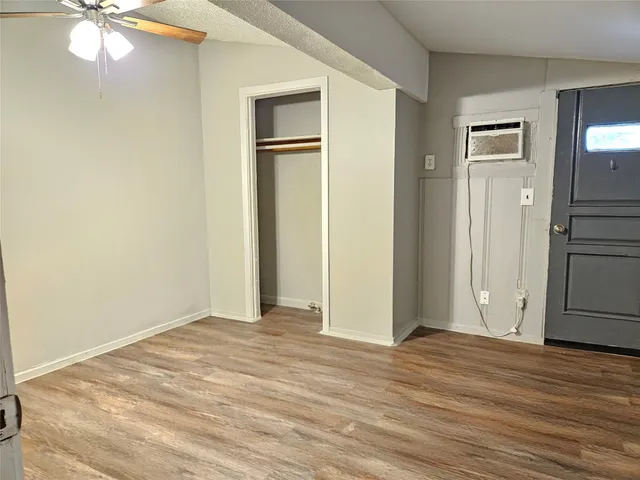 a view of a livingroom with wooden floor and a ceiling fan
