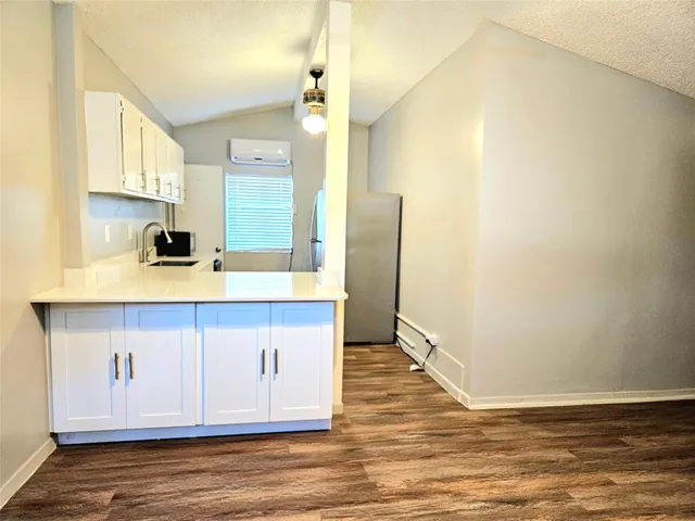 a kitchen with stainless steel appliances a sink and a refrigerator