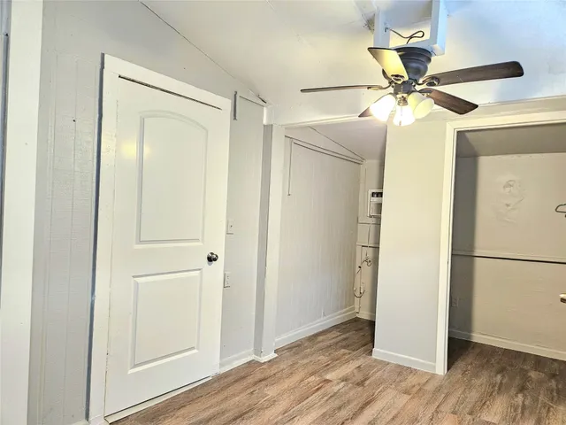 a view of a chandelier fan and wooden floor