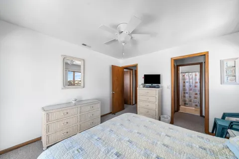 a bedroom with a bed and a dresser