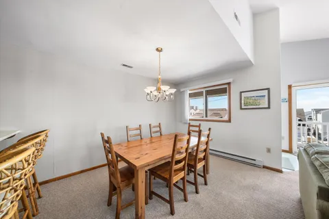 a view of a dining room with furniture and chandelier