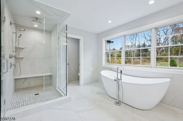a large kitchen with stainless steel appliances and white cabinets