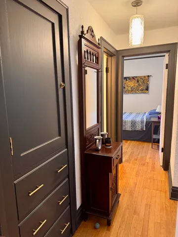 a room with wooden floor and gym equipment