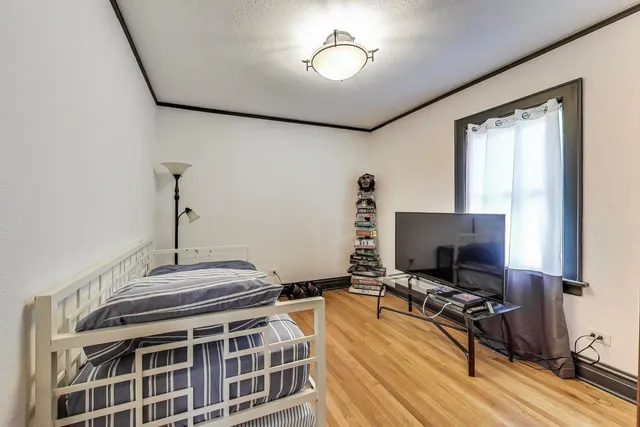 a bedroom with a bed and a book shelf