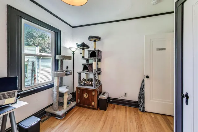 a view of a hallway view with wooden floor and staircase