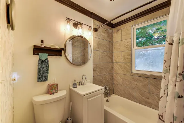 a bedroom with a bed and large windows