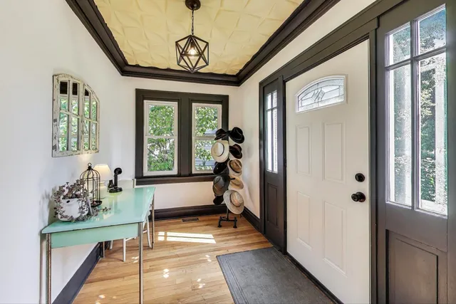 a view of hallway with furniture and windows