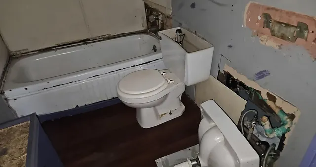 a kitchen with granite countertop sink and cabinets