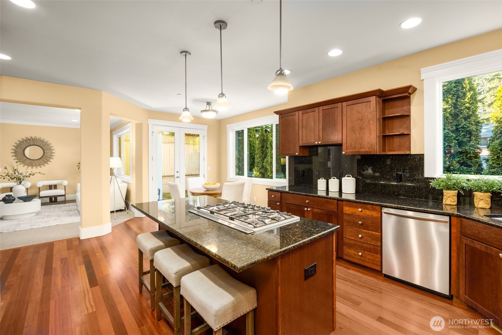 18638 92nd Avenue Northeast Bothell, WA 98011 - Photo 5 of 40 a kitchen with stainless steel appliances granite countertop a stove a sink dishwasher and a dining table with wooden floor