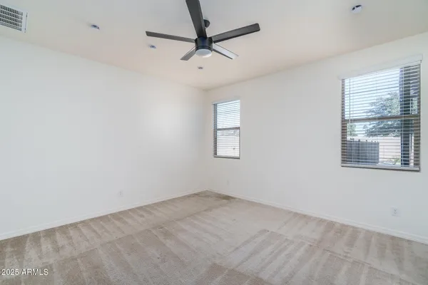 an empty room with kitchen view and a window