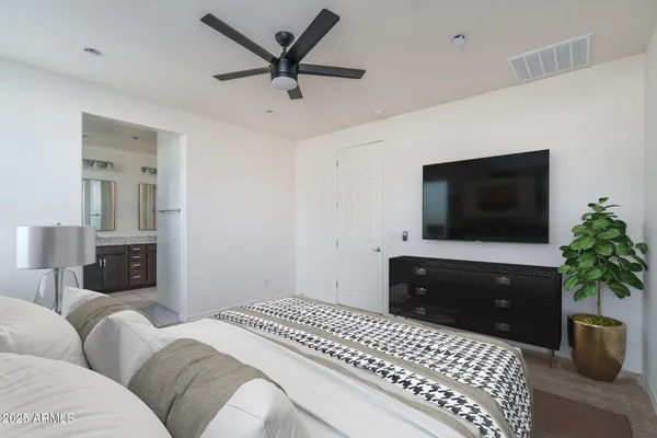 a bedroom with a bed and a painting on the wall