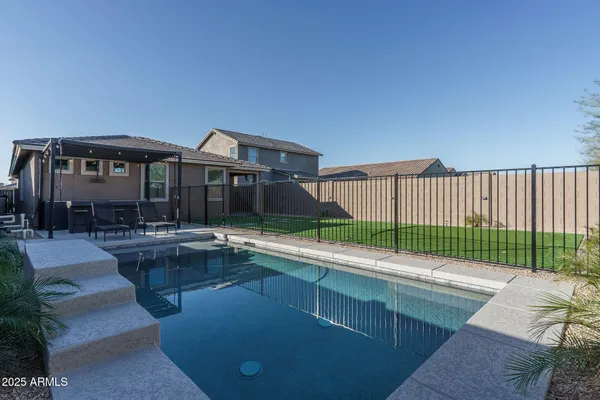 a view of a backyard with a garden and deck