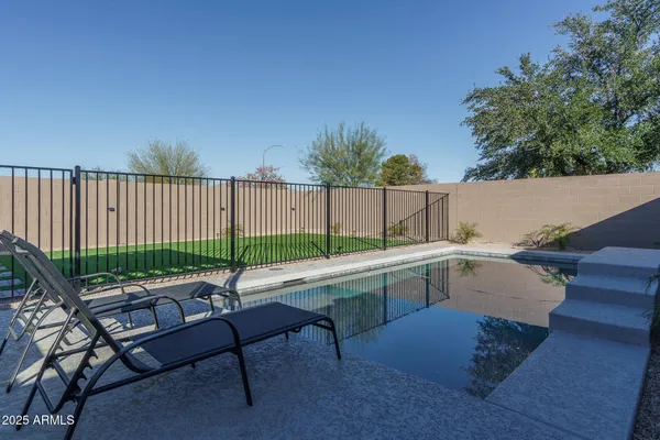 a backyard of a house with table and chairs