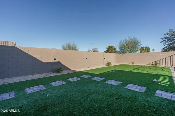a view of backyard with seating area and green space