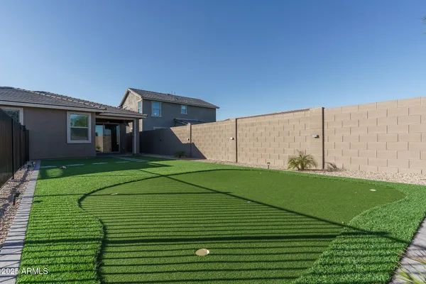 a view of a back yard with a small pool
