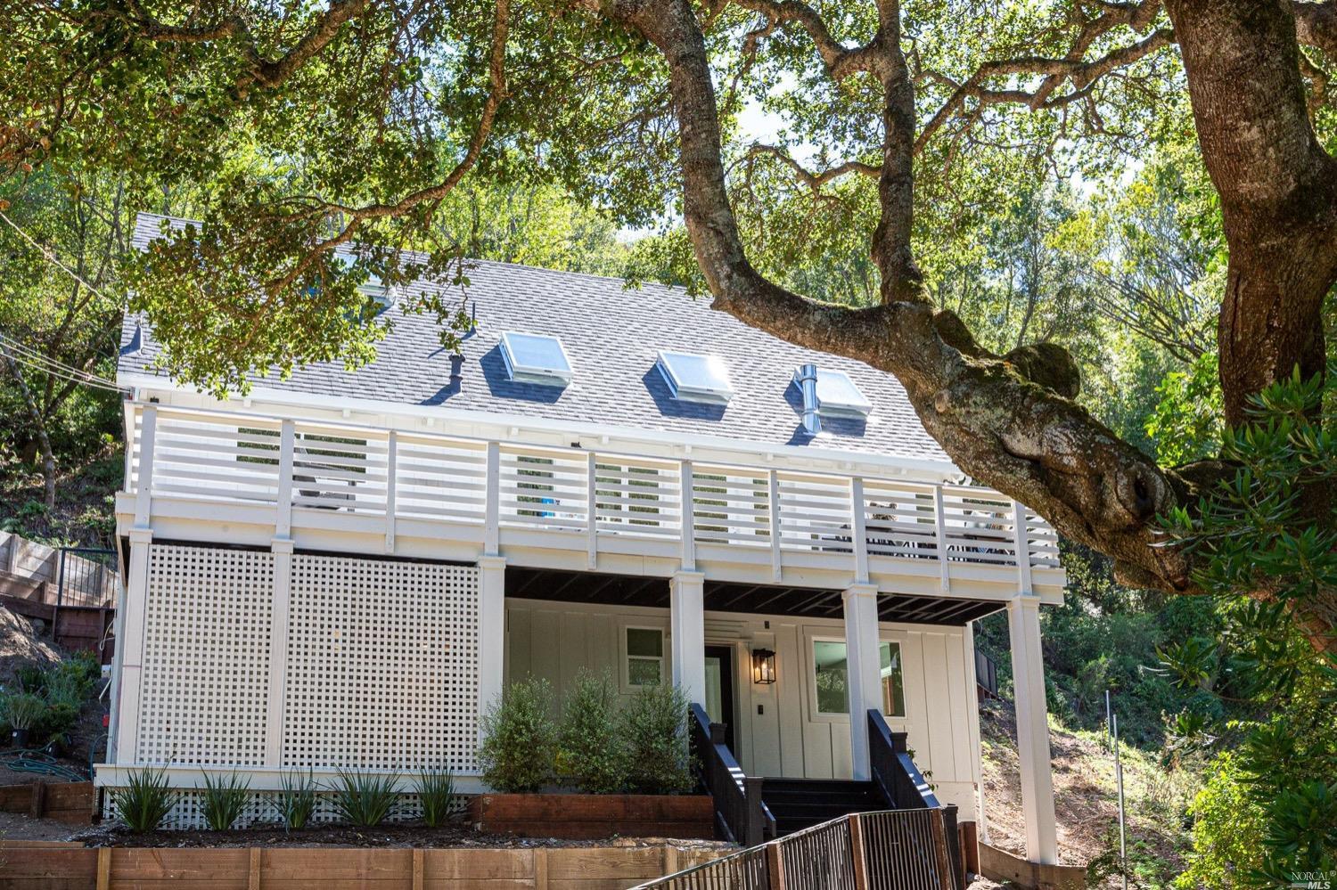 a view of a house with a tree