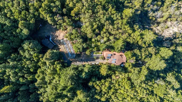 an aerial view of a house with a yard and garden