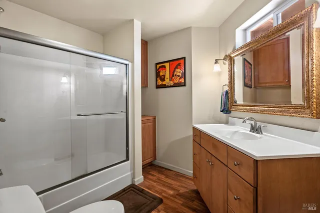 a bathroom with a shower sink and mirror