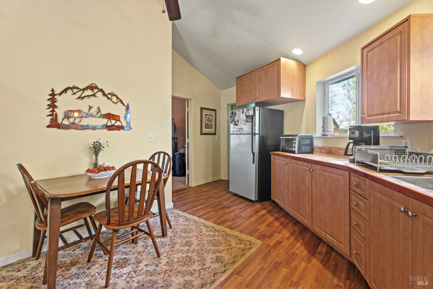 16460 Walker Lake Road Willits, CA 95490 - Photo 10 of 23 a kitchen with stainless steel appliances granite countertop a refrigerator a sink a stove a dining table and chairs