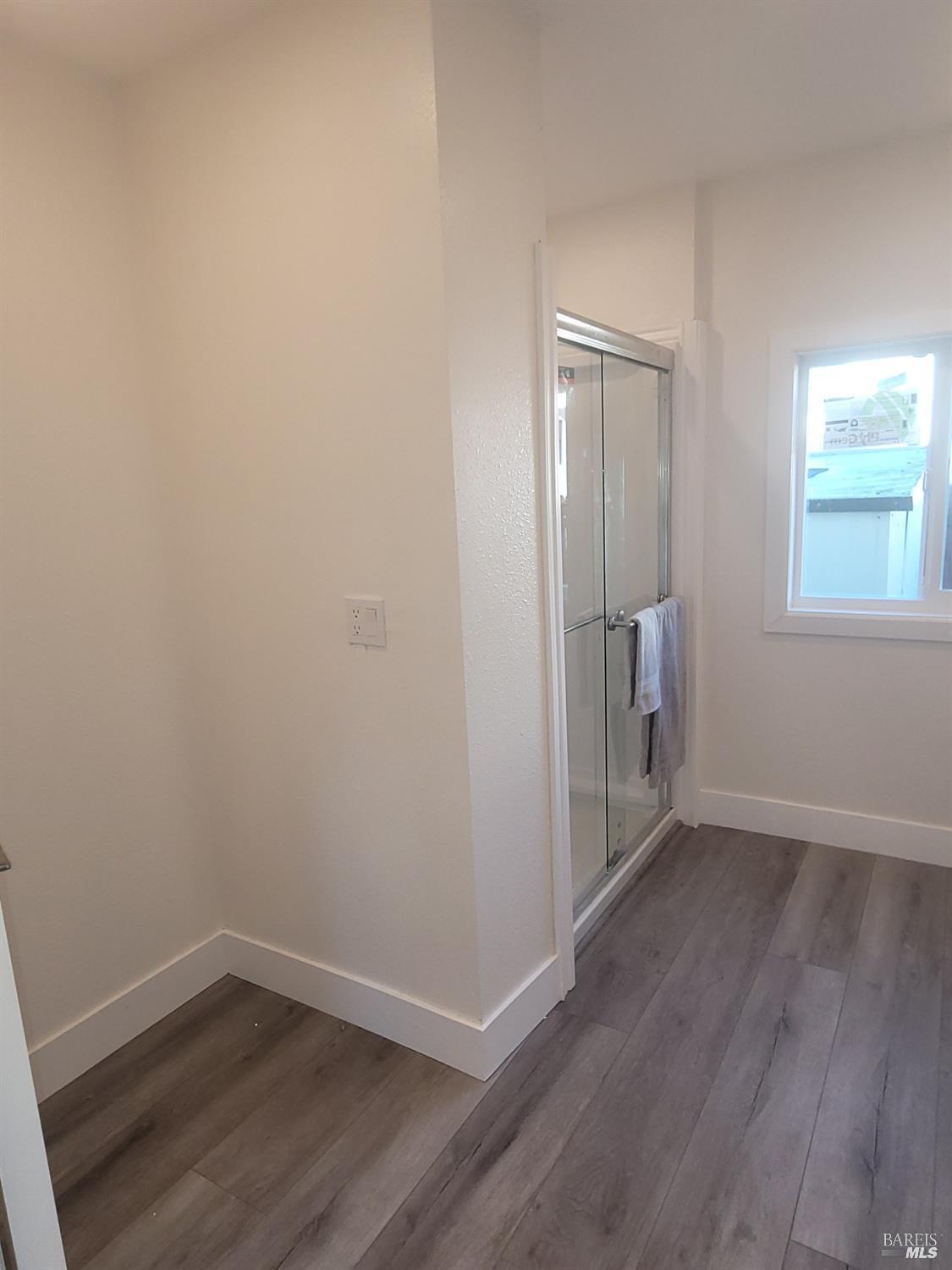 839 Nonie Street Santa Rosa, CA 95403 - Photo 13 of 23 an empty room with wooden floor and windows