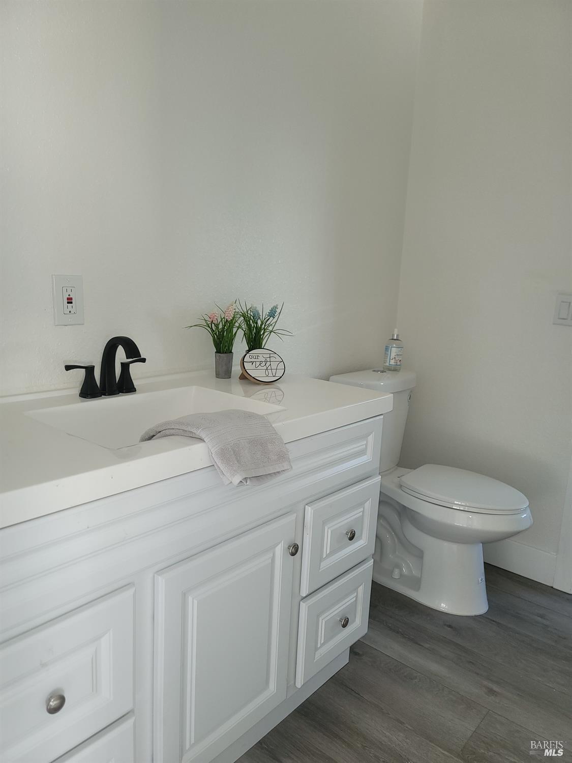 839 Nonie Street Santa Rosa, CA 95403 - Photo 14 of 23 a bathroom with a granite countertop toilet sink and mirror