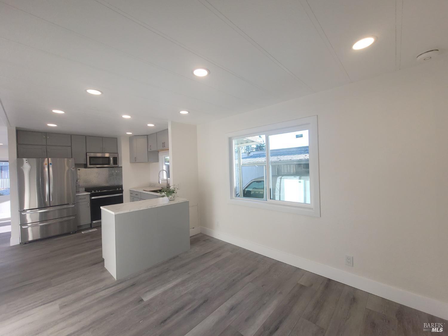 839 Nonie Street Santa Rosa, CA 95403 - Photo 6 of 23 a large kitchen with a large counter top a sink stainless steel appliances and cabinets