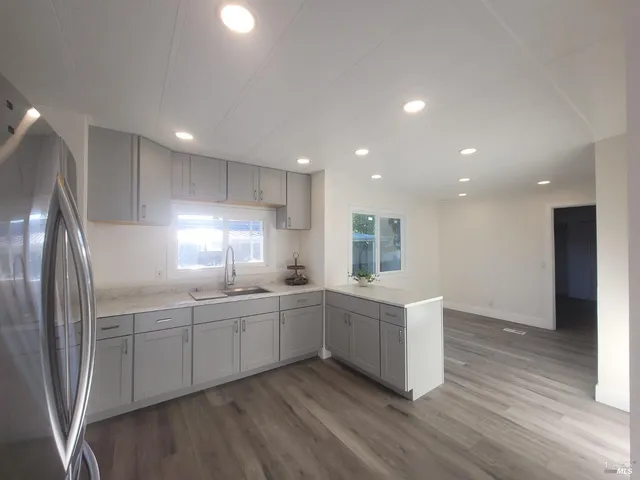 a kitchen with counter top space sink and refrigerator