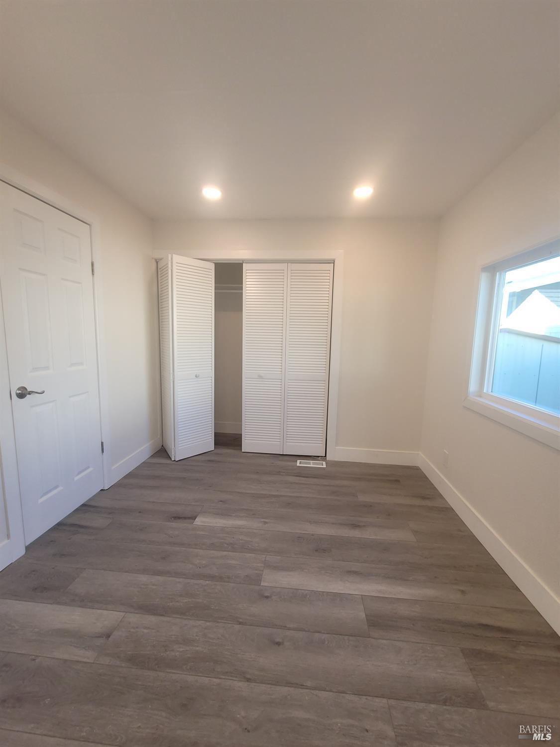 839 Nonie Street Santa Rosa, CA 95403 - Photo 10 of 23 a view of an empty room with wooden floor and window