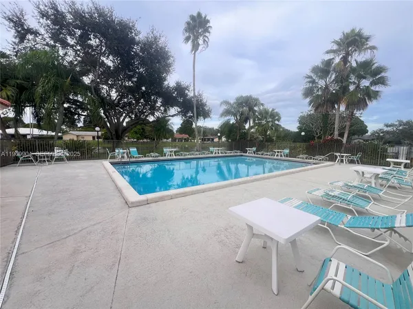 a view of a swimming pool with lounge chairs